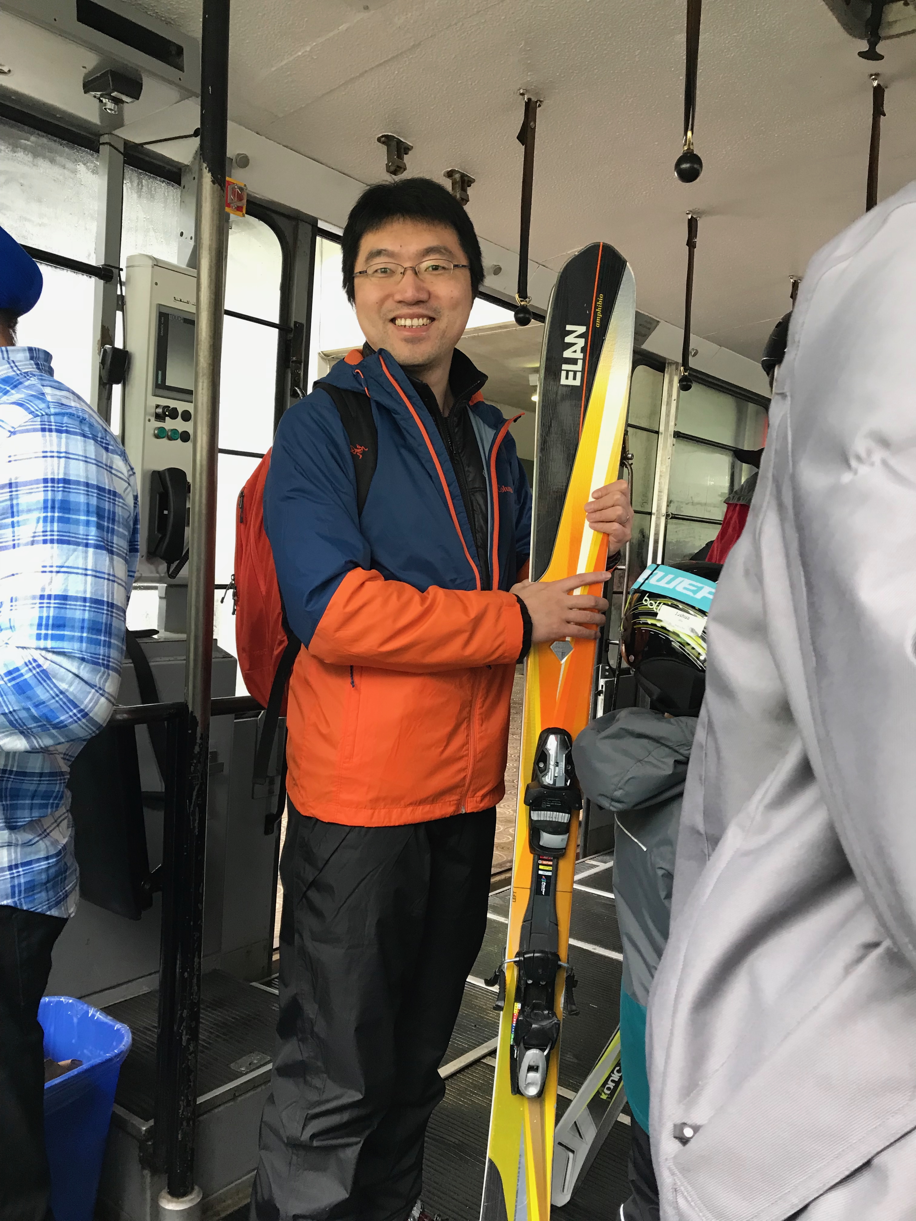 Riding the gondola with skiing equipment